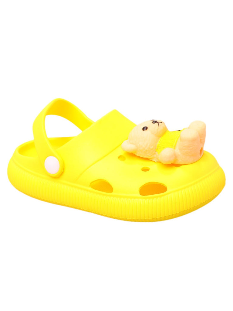 Single yellow clog with teddy bear detail viewed from the side against a contrasting blue background