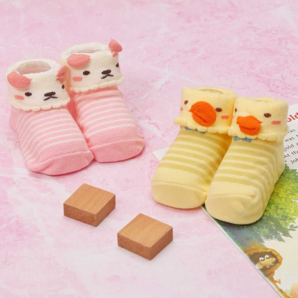 Pink and white striped baby girl socks with a cute puppy face and ears on the cuffs.