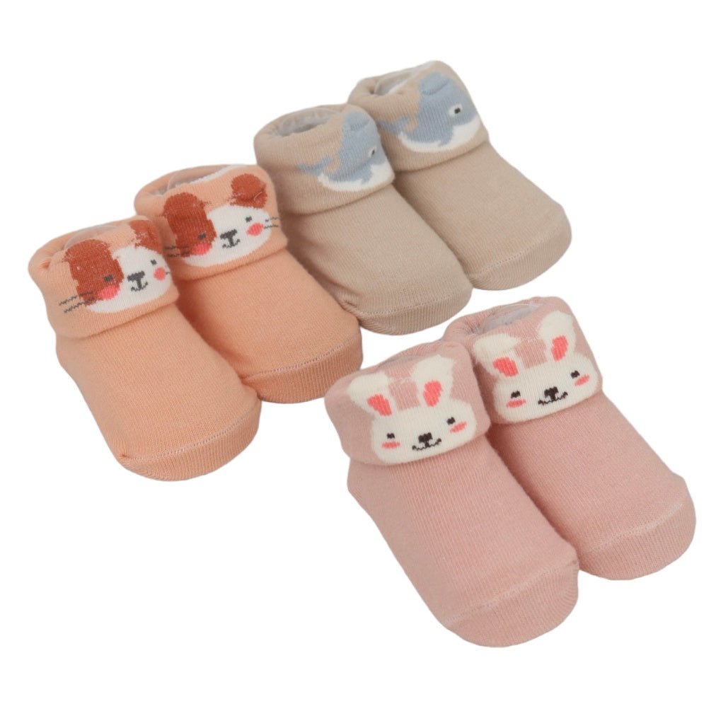 A set of cozy baby booties with animal faces in pastel tones.