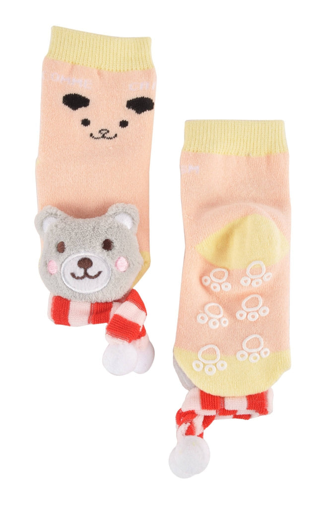 Laid flat view of peach-colored toddler socks with teddy bear plush and anti-slip design