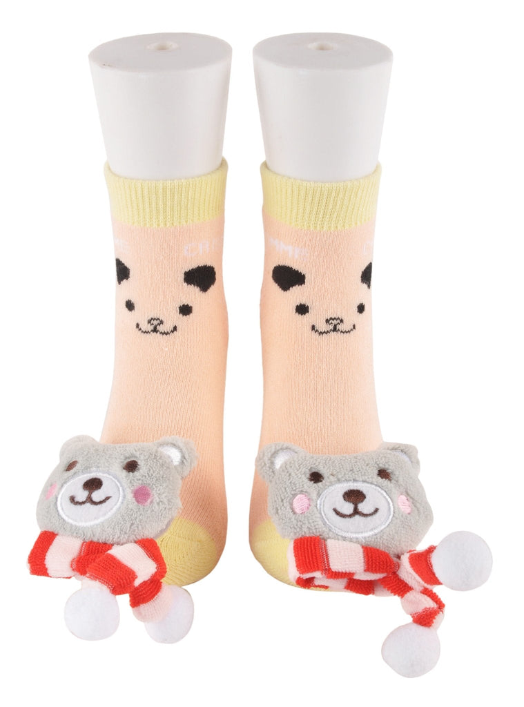 Front view of teddy bear toy socks on mannequin feet with smiling bear face