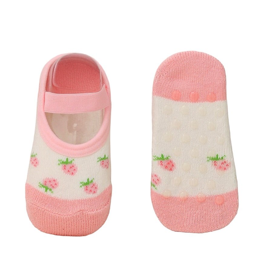 Image of the bottom of pink strawberry print cotton-leather socks for baby girls, highlighting the anti-slip texture.