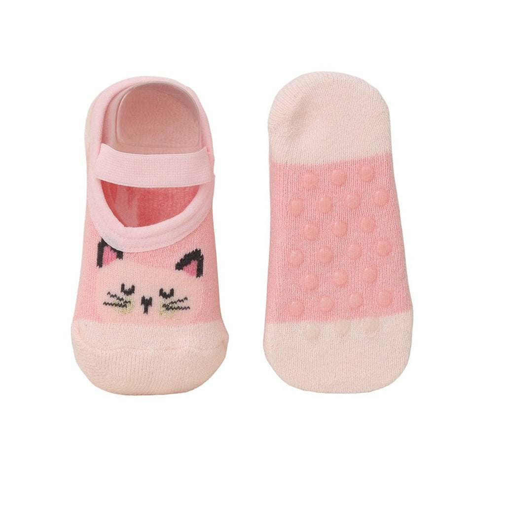 Image of the bottom of pink kitty print cotton-leather socks for baby girls, showcasing the anti-slip design.