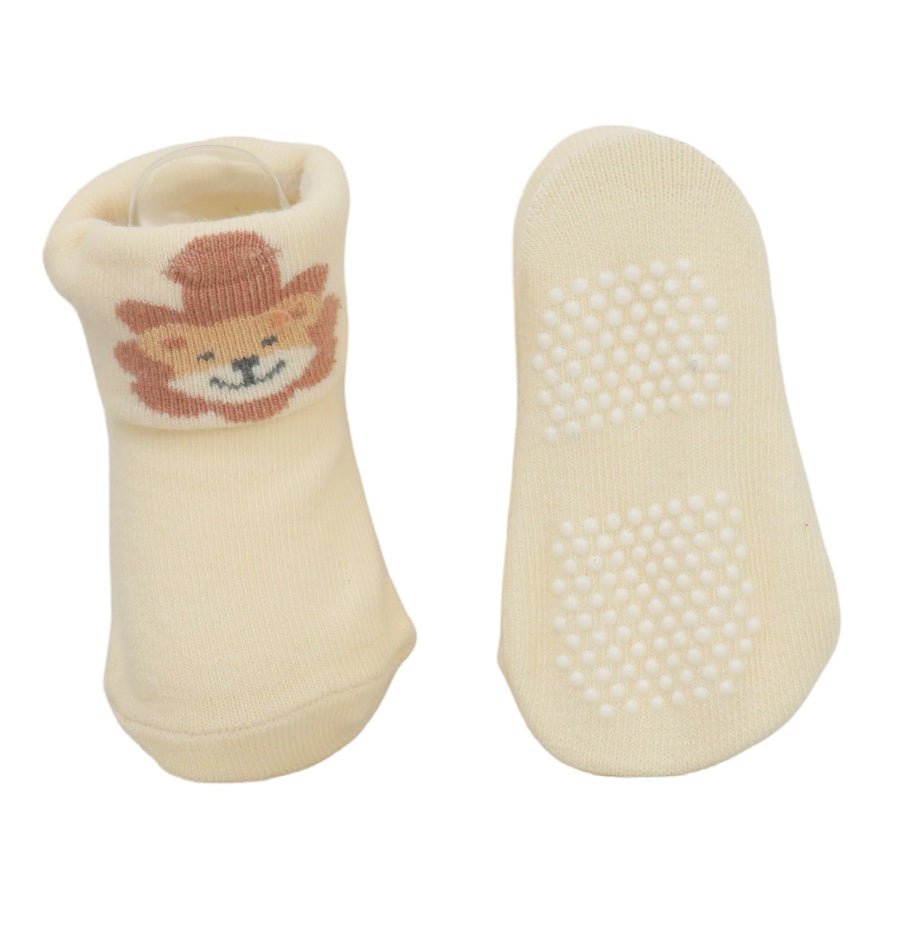Cream-colored infant socks with lion print showing anti-skid soles, top and bottom 