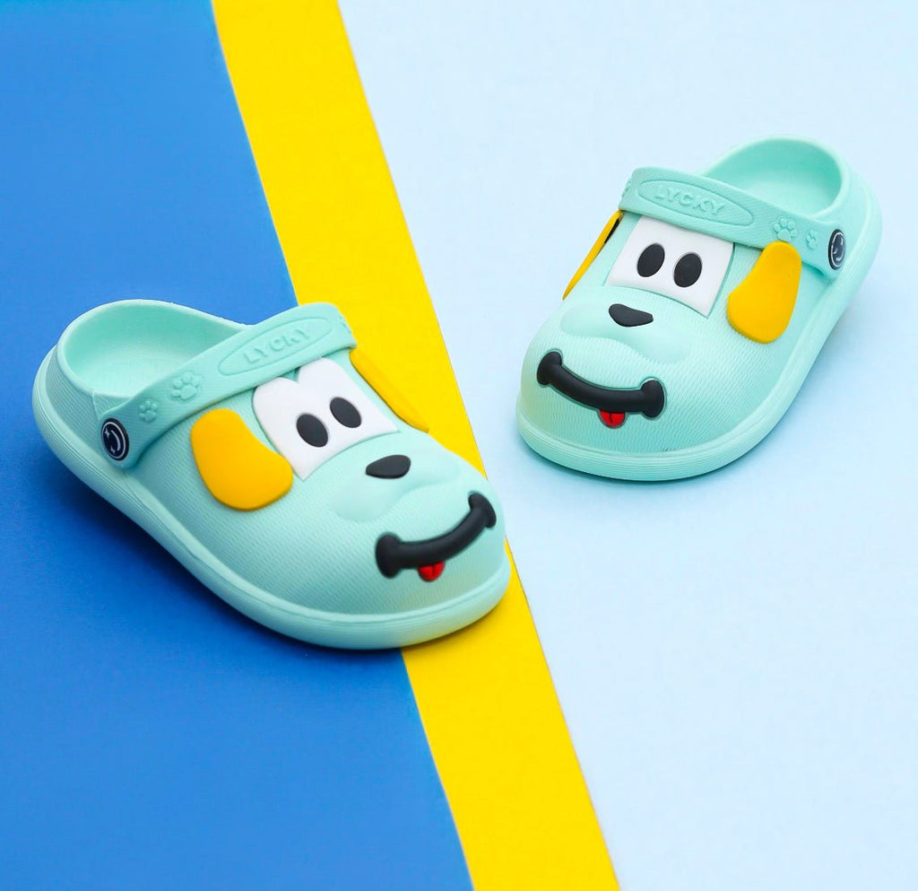Light blue boys' clogs with a cute puppy face design on a striped background.