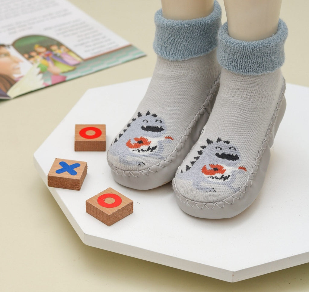 Child's grey leather socks with cute dinosaur print and soft blue cuffs