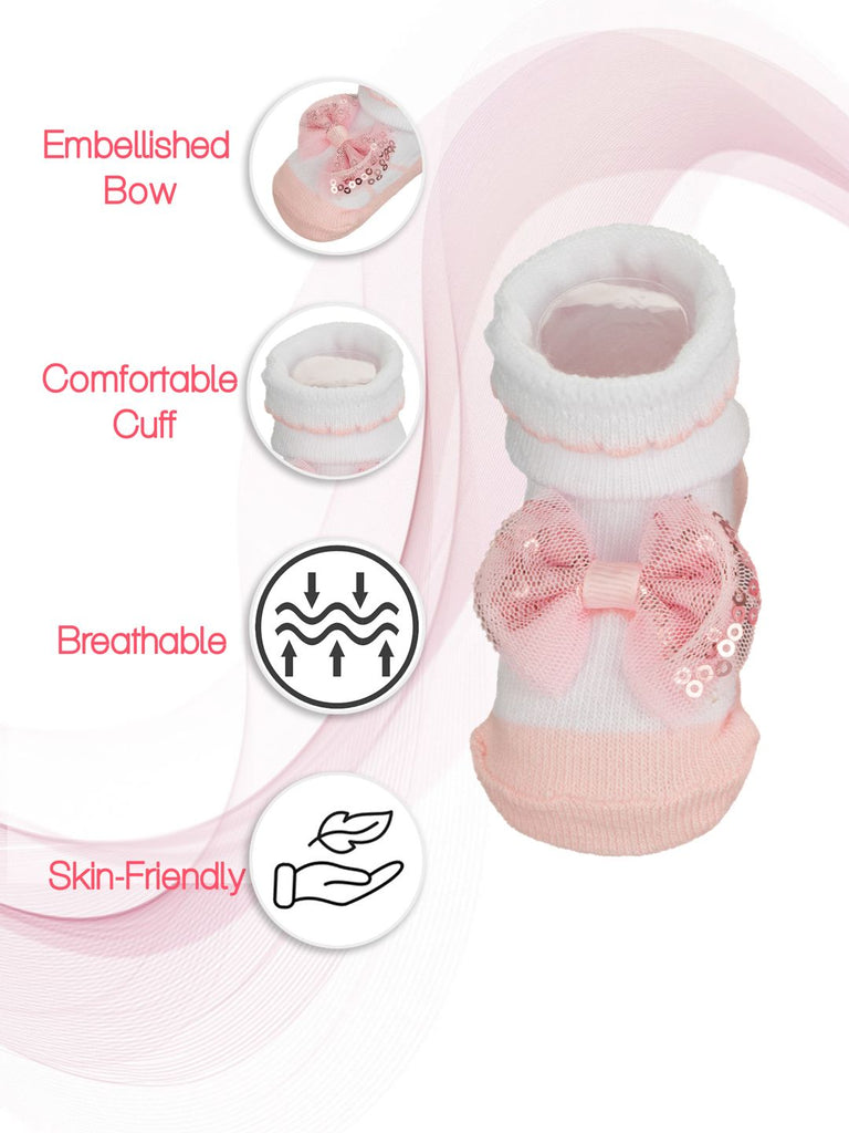 White baby sock with a delicate pink embellished bow and comfortable cuff