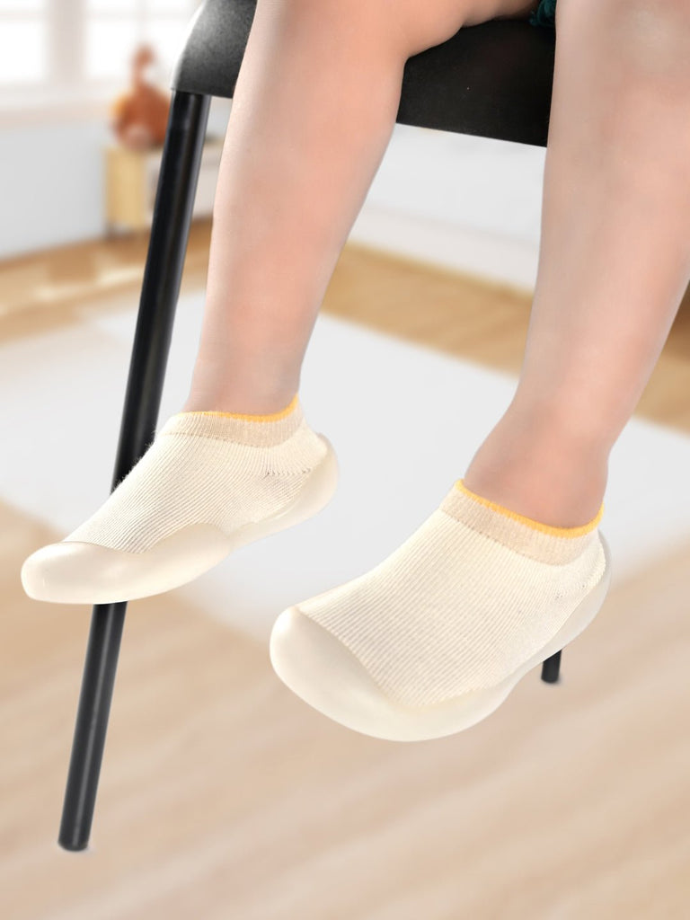 Toddler's feet comfortably placed in Yellow Bee's Cream Solid Shoe Socks with anti-skid sole