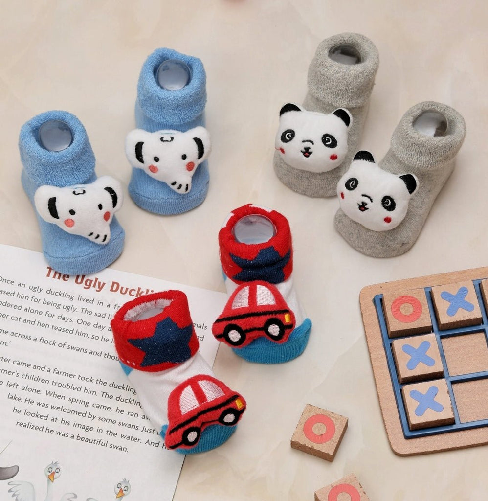 Assortment of kids' socks with elephant, panda, and car designs displayed on a playful background.