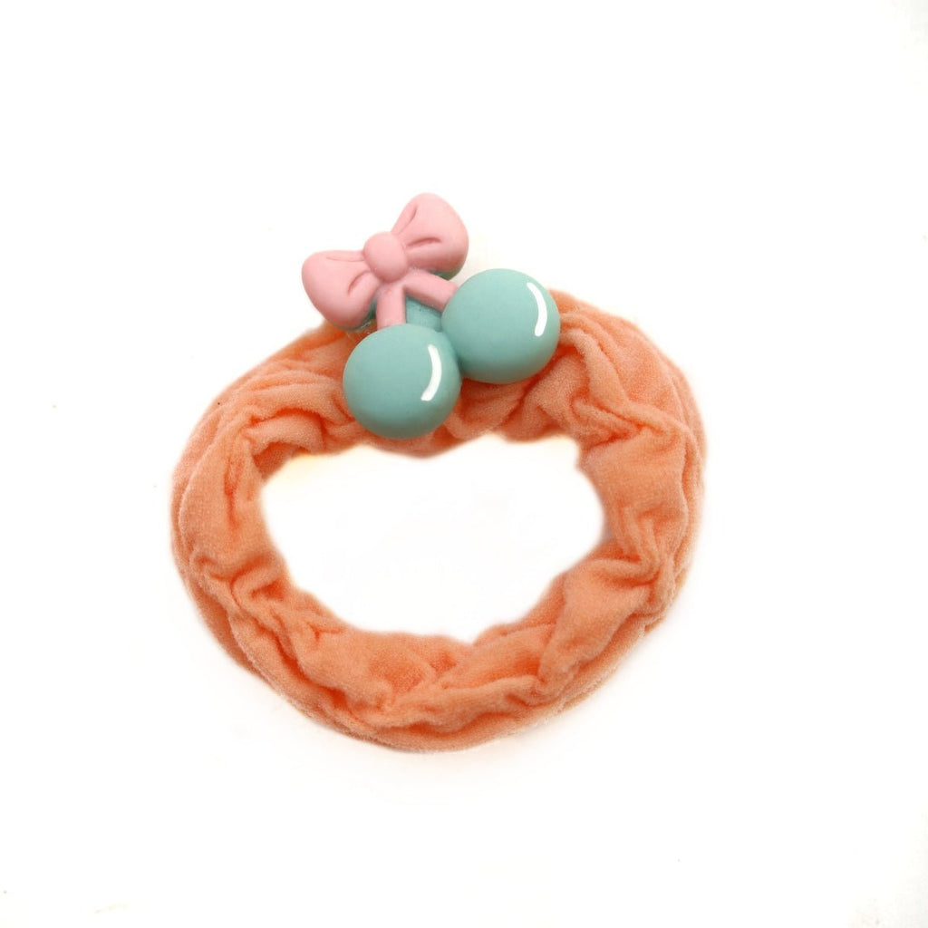 Peach rubber band featuring a cherry, part of the Yellow Bee girls' collection.