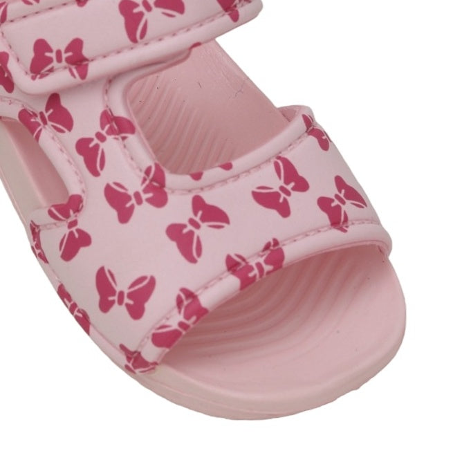 Close-up of the bow pattern on the strap of a child's pink sandal
