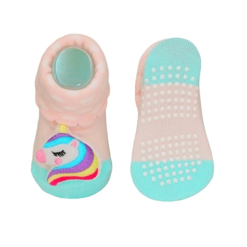 Baby girls' turquoise unicorn socks showing the anti-slip sole.