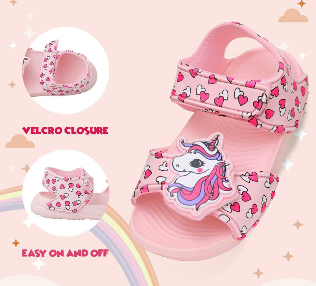  Infographic Side view of kids' peach sandals featuring a unicorn charm and heart prints, showcasing velcro fastening