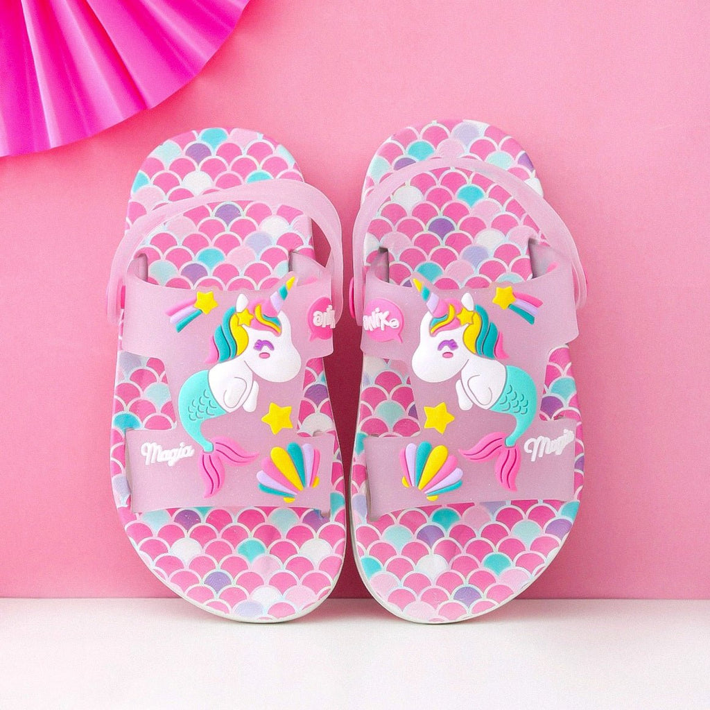 Overhead view of pink unicorn sandals with transparent straps and whimsical design on a pink background.