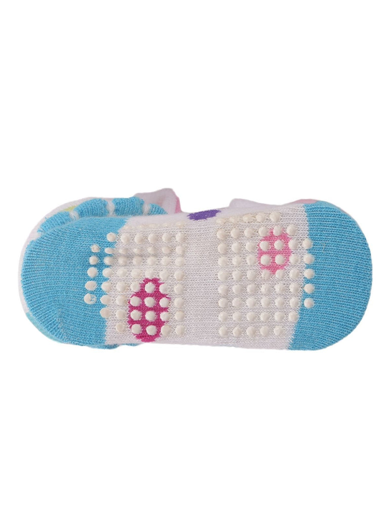 Bottom view of infant socks with bunny toy showing non-slip grip pattern.