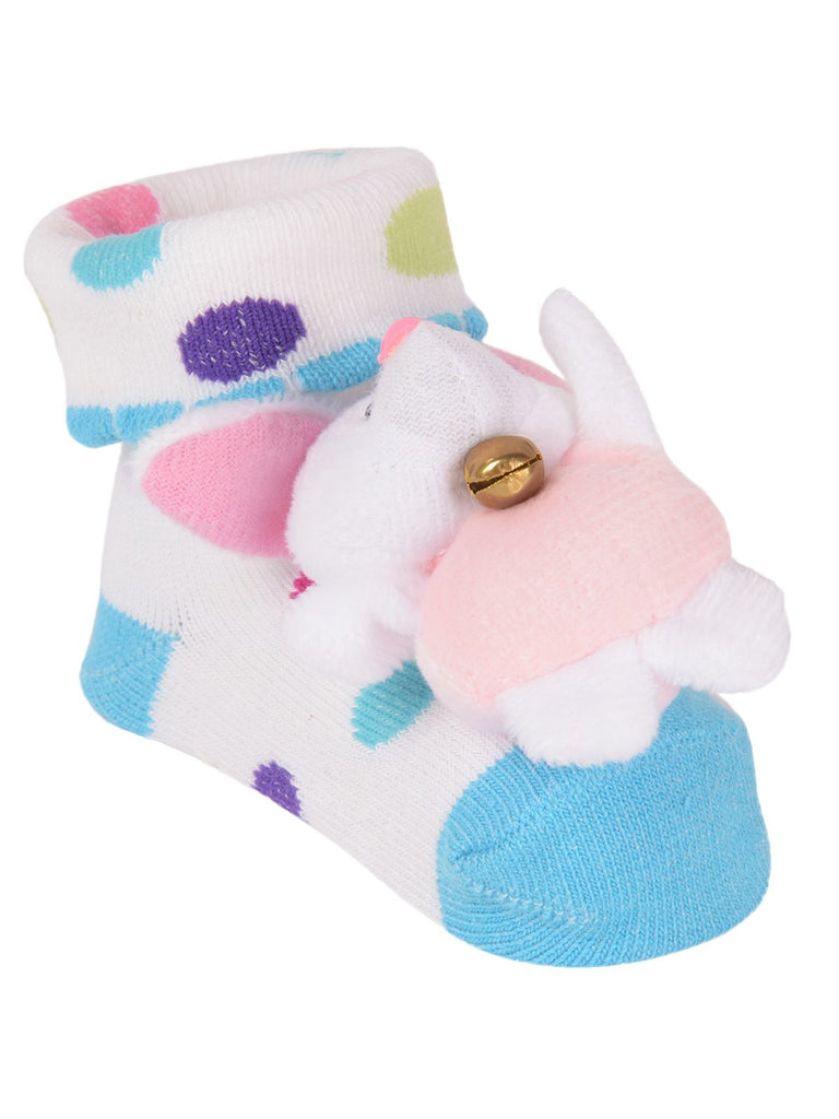 Side angle of white socks with plush bunny toy for infants featuring colorful polka dots.
