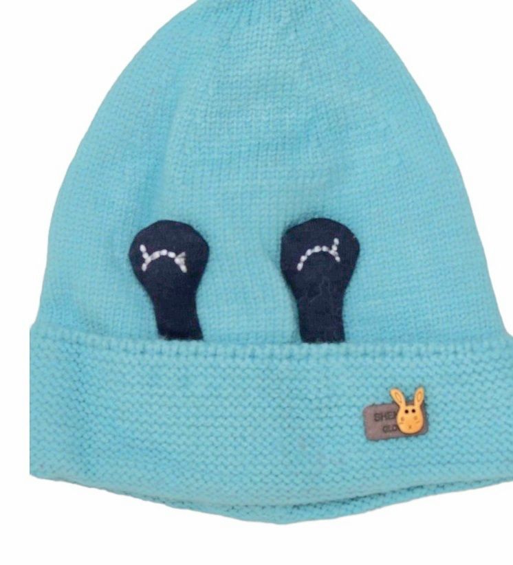 Side view of light blue winter beanie with eye applique, perfect for toddlers