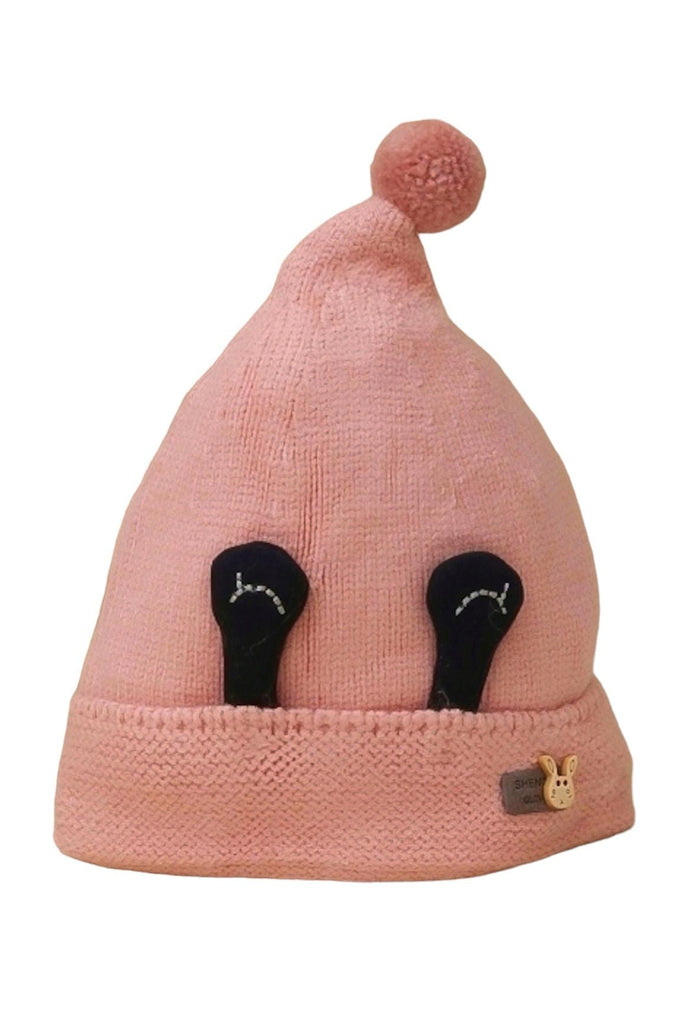 Cozy pink knitted beanie with eye decorations and pom-pom for young girls.