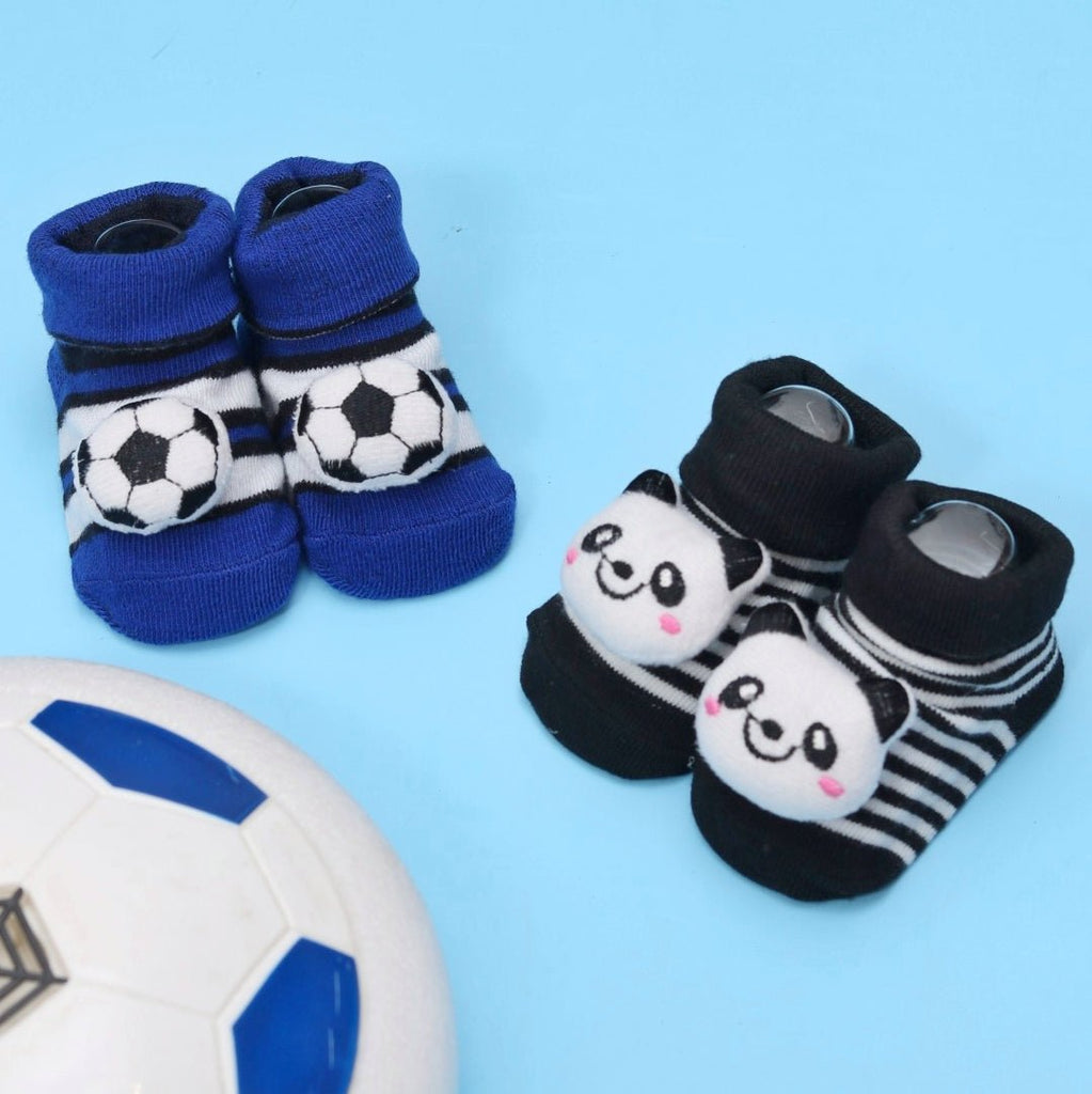 Blue football and black panda patterned baby socks set with a soccer ball on a blue background.