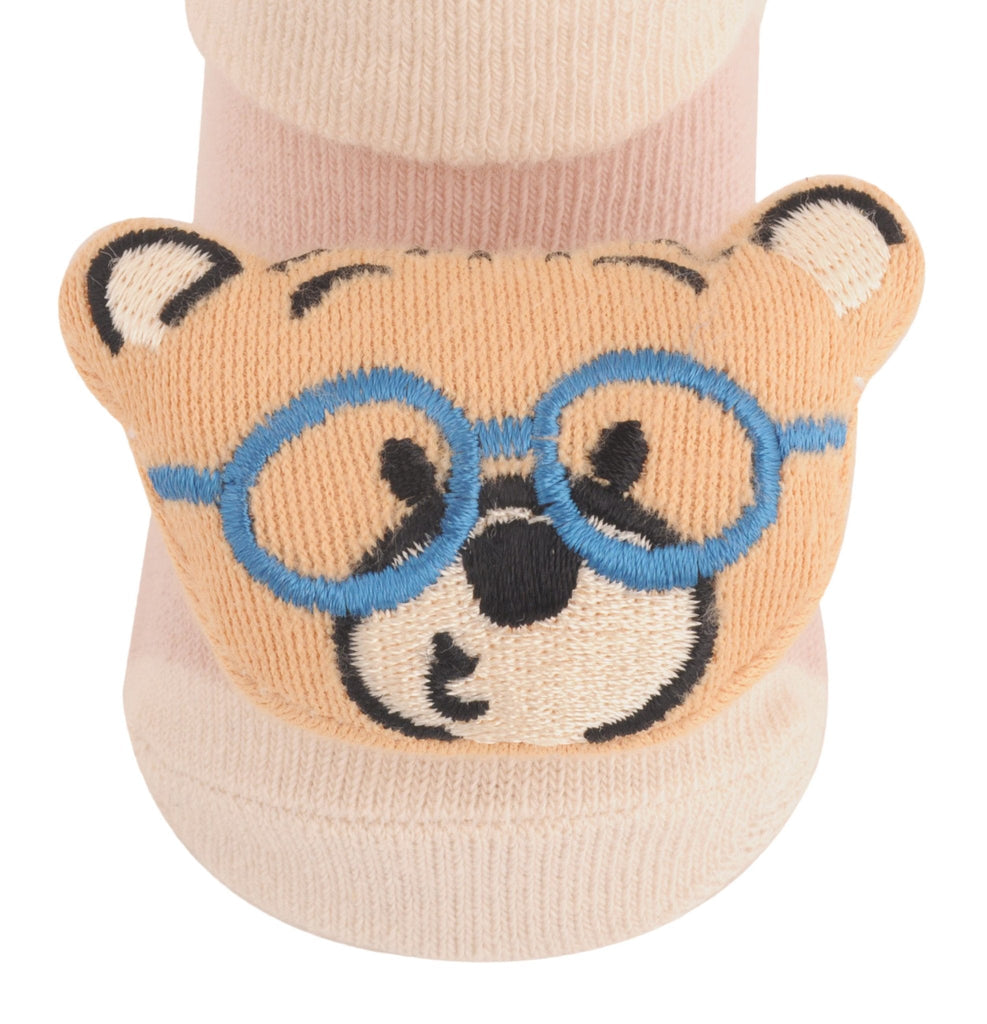 Close-up of children's beige teddy bear sock with cute blue glasses detail