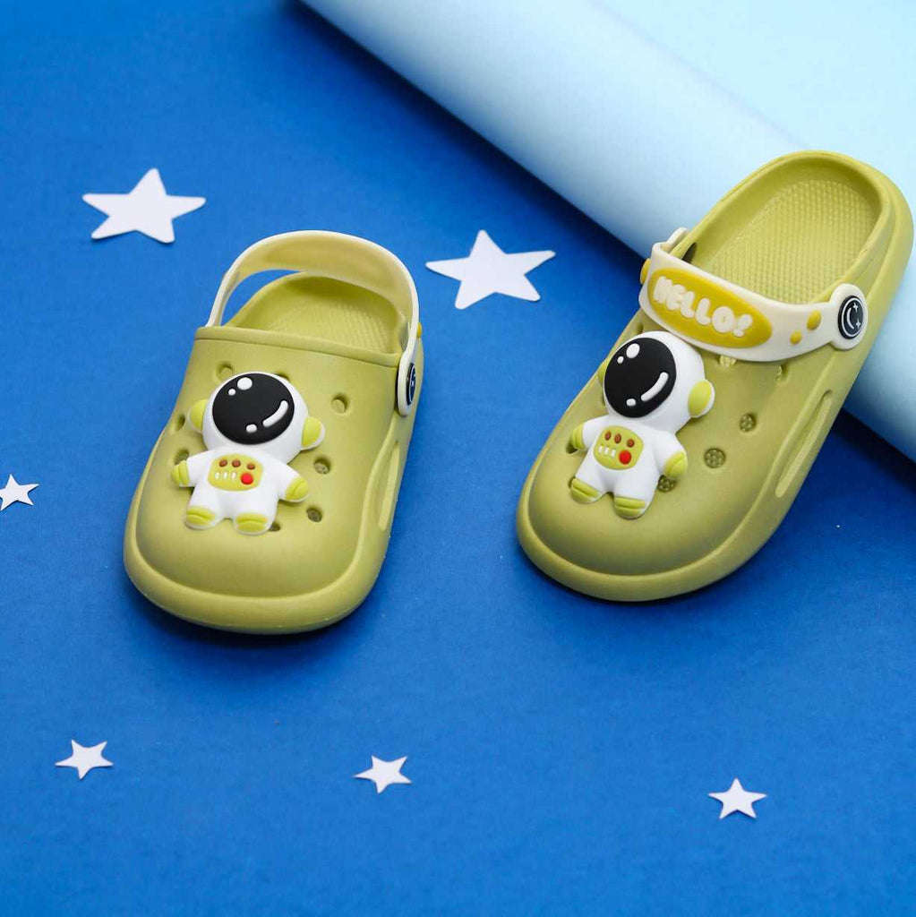 Kids' olive green clogs with playful astronaut design on a starry background