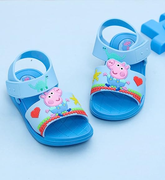 Frontal view of kids' George Pig sandals in blue, highlighting the playful character embellishments.