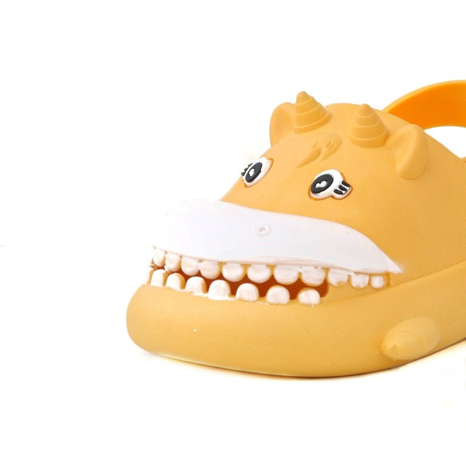 Close-up of the front of a yellow hippo clog with a wide, happy grin.