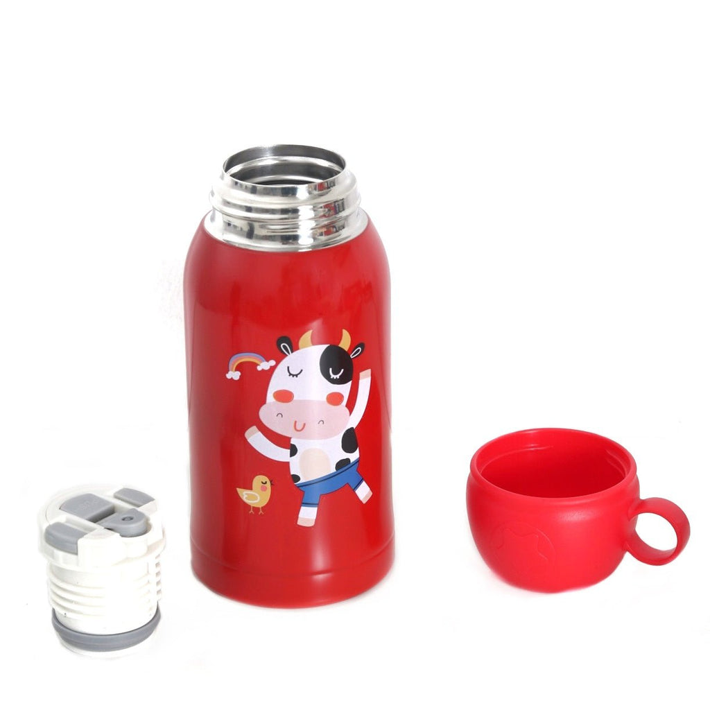 Open Yellow Bee Cow Red Thermos Flask next to a red cup on a wooden stand