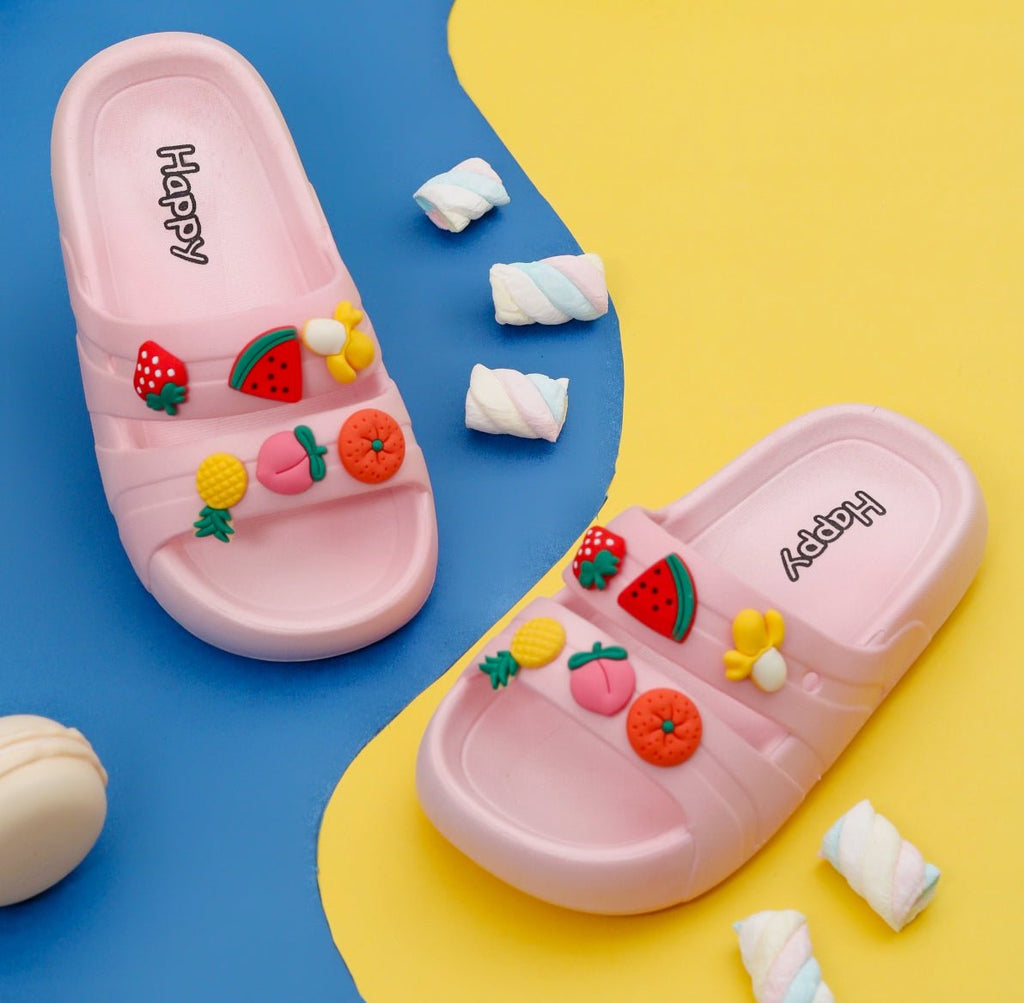 Kids' Juicy Delight Fruits Motif Slides in Soft Peach Amidst Playful Toys