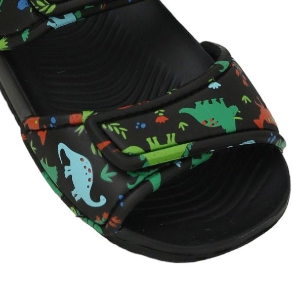 Close-up view of kids' black sandal strap with colorful dinosaur print detailing.