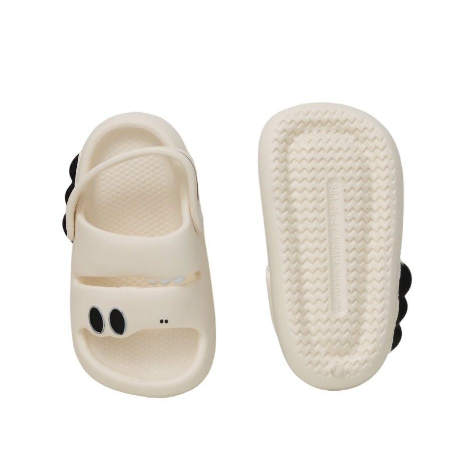  Top and bottom view of white dino sandals, displaying the anti-slip sole and dino eye details.