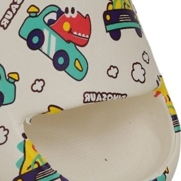 Close-up of a child's sandal highlighting the cheerful dinosaur-in-cars print design.