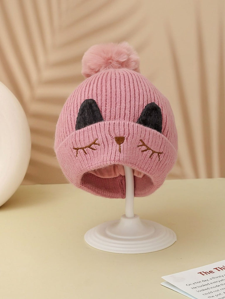 Adorable dark pink winter beanie with kitten face and pom-pom for girls.