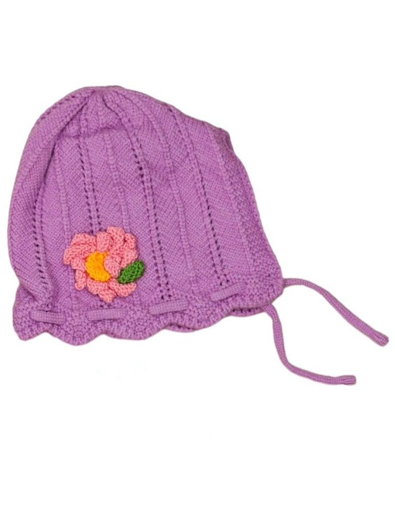 Top view of a purple knitted toddler beanie with a cute flower detail on the side.