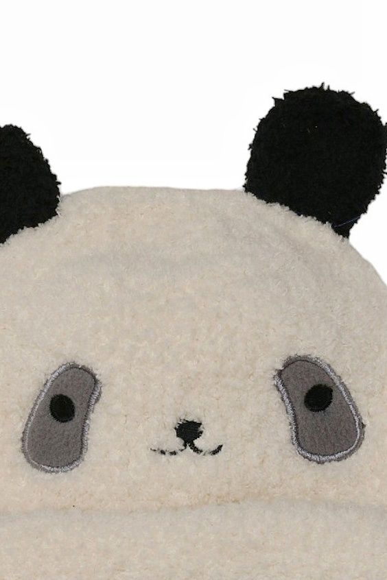 Close-up of the panda beanie's facial details, featuring stitched eyes and nose on a white background.