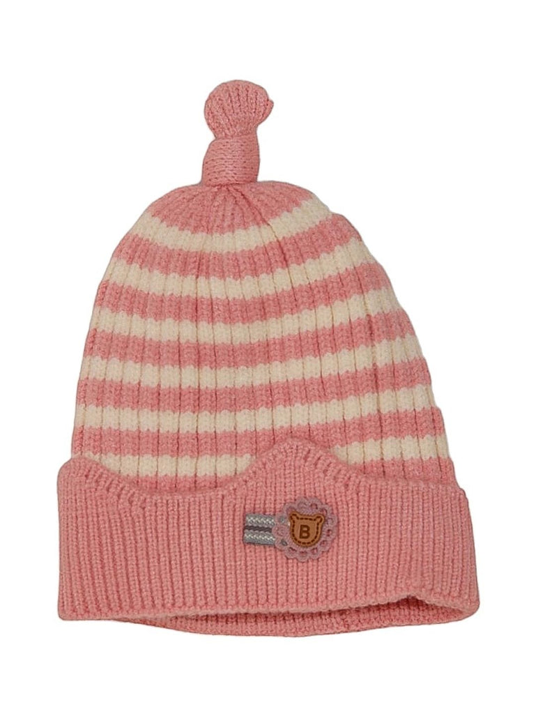 Front view of a light pink knitted beanie with white stripes, featuring a branded badge detail for added charm.