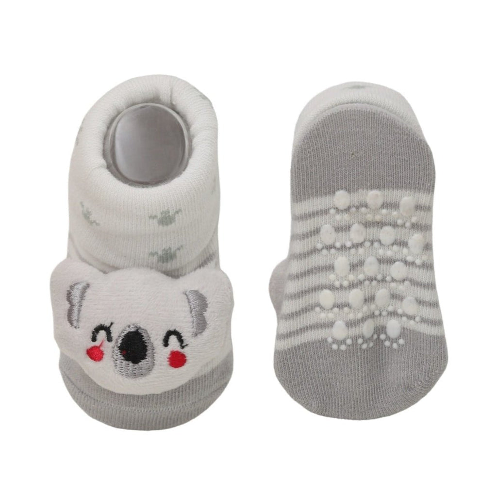 White socks with a cartoon teddy plush toy on the top for babies.