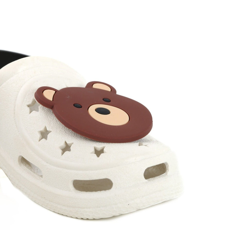 Close-up of the bear face on a child's beige clog with star details