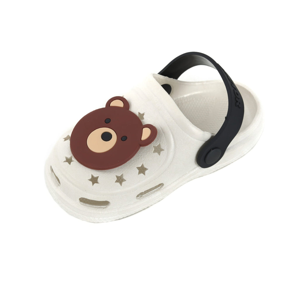 Angled view of a kid's beige clog with bear face motif and contrasting black strap