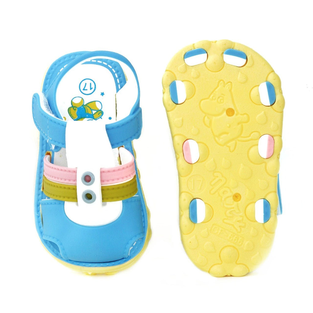 Underside of blue toddler sandals displaying the non-slip yellow sole with cute patterns.
