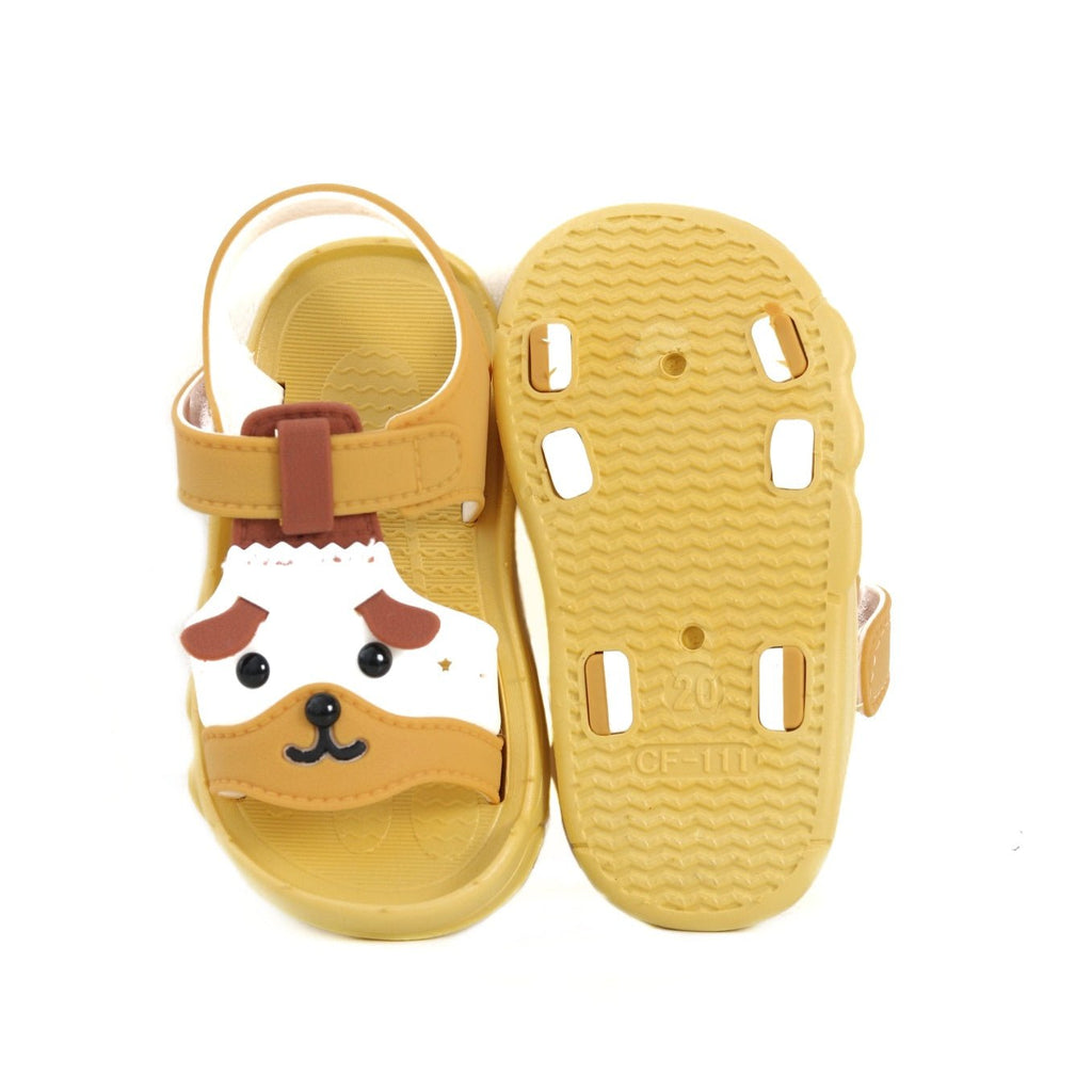 Sole view of yellow puppy sandals showcasing the non-slip tread and cute paw prints.