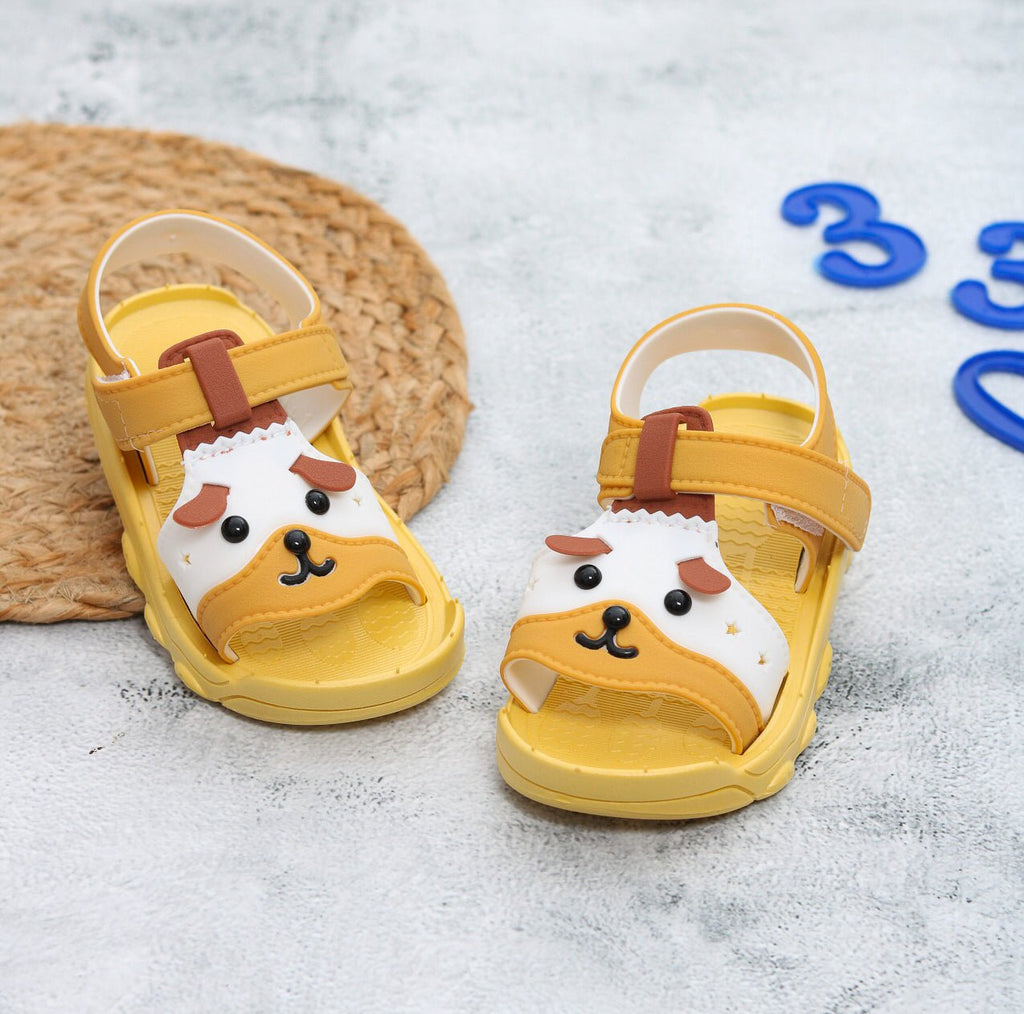  Top view of yellow puppy sandals with playful puppy face applique and secure straps.