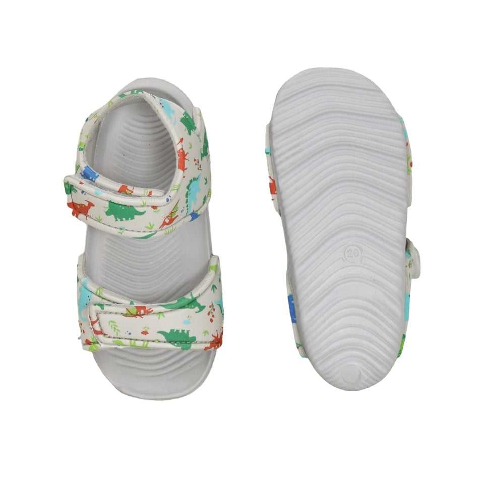 Pair of grey kids' sandals with a dinosaur print, showcasing both the strap design and sole pattern.