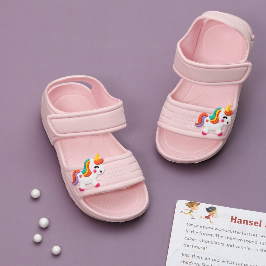 "Pair of Kids' Magical Steps Peach Unicorn Sandals on a Lavender Background
