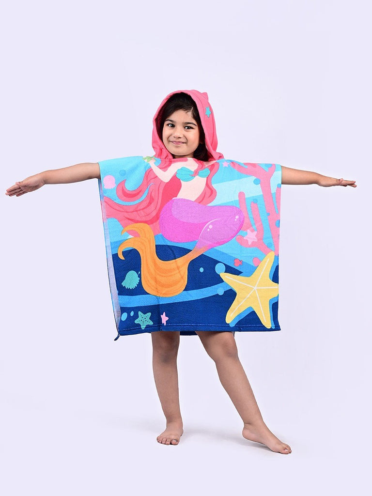 Girl smiling in a pink and aqua mermaid hooded poncho towel by Yellow Bee