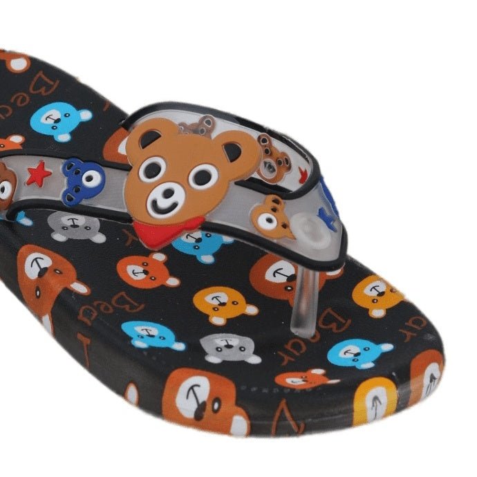 Close-up of the charming bear face on the strap of the black flip flops