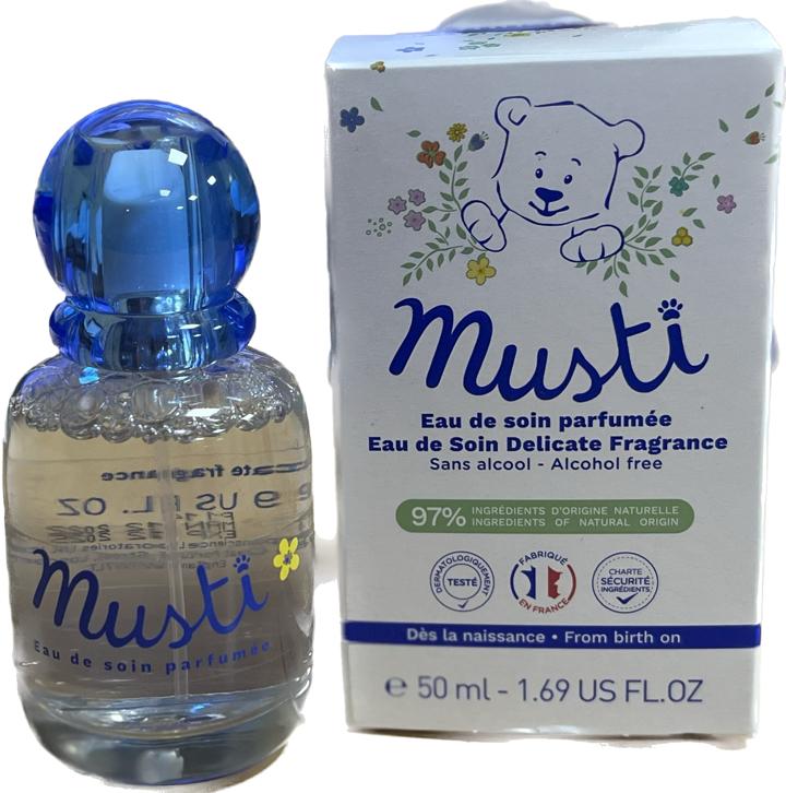 Mustela Musti fragrance bottle alongside its box, highlighting the product's elegant and child-friendly design