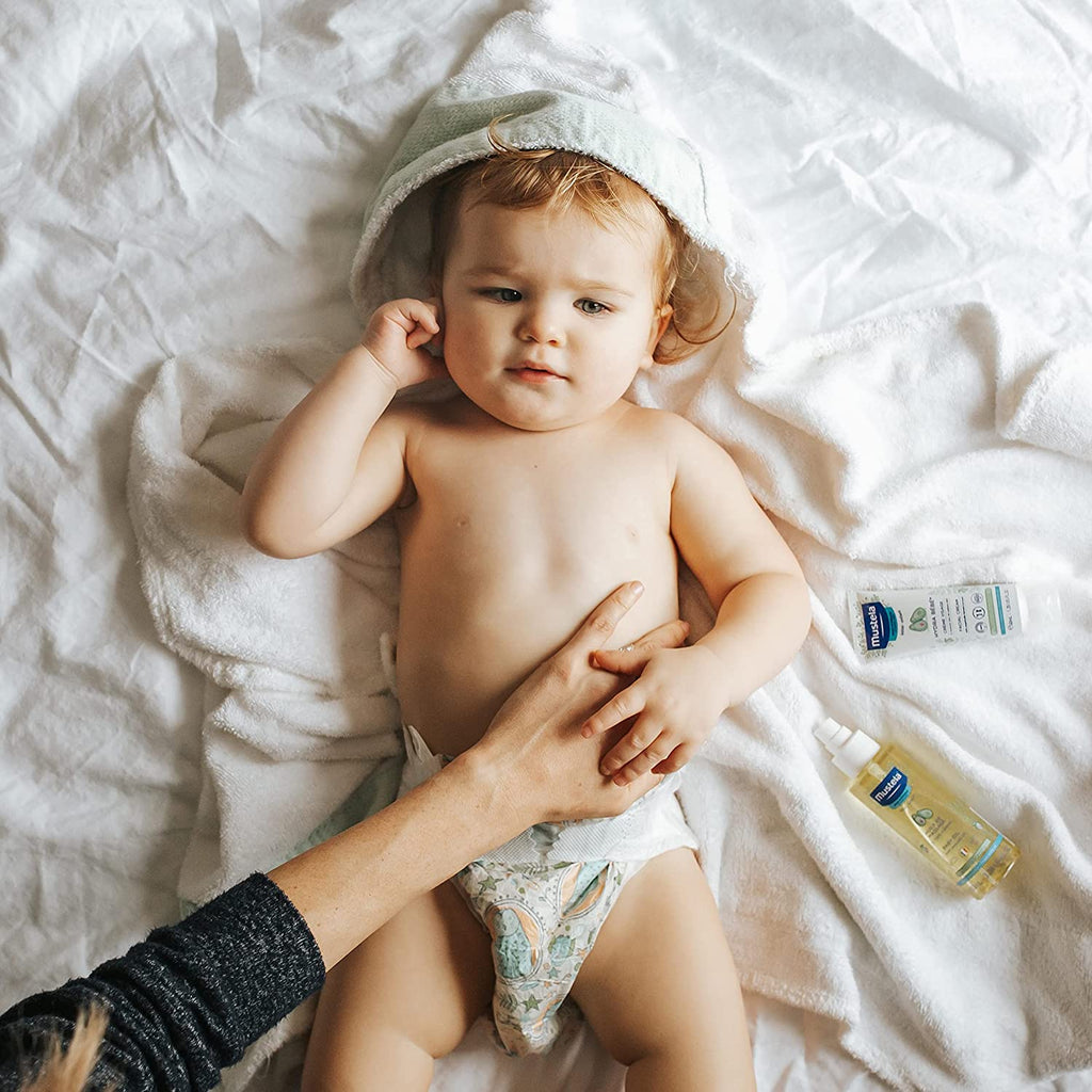 Baby Being Massaged with Mustela Baby Oil for Skin Nourishment