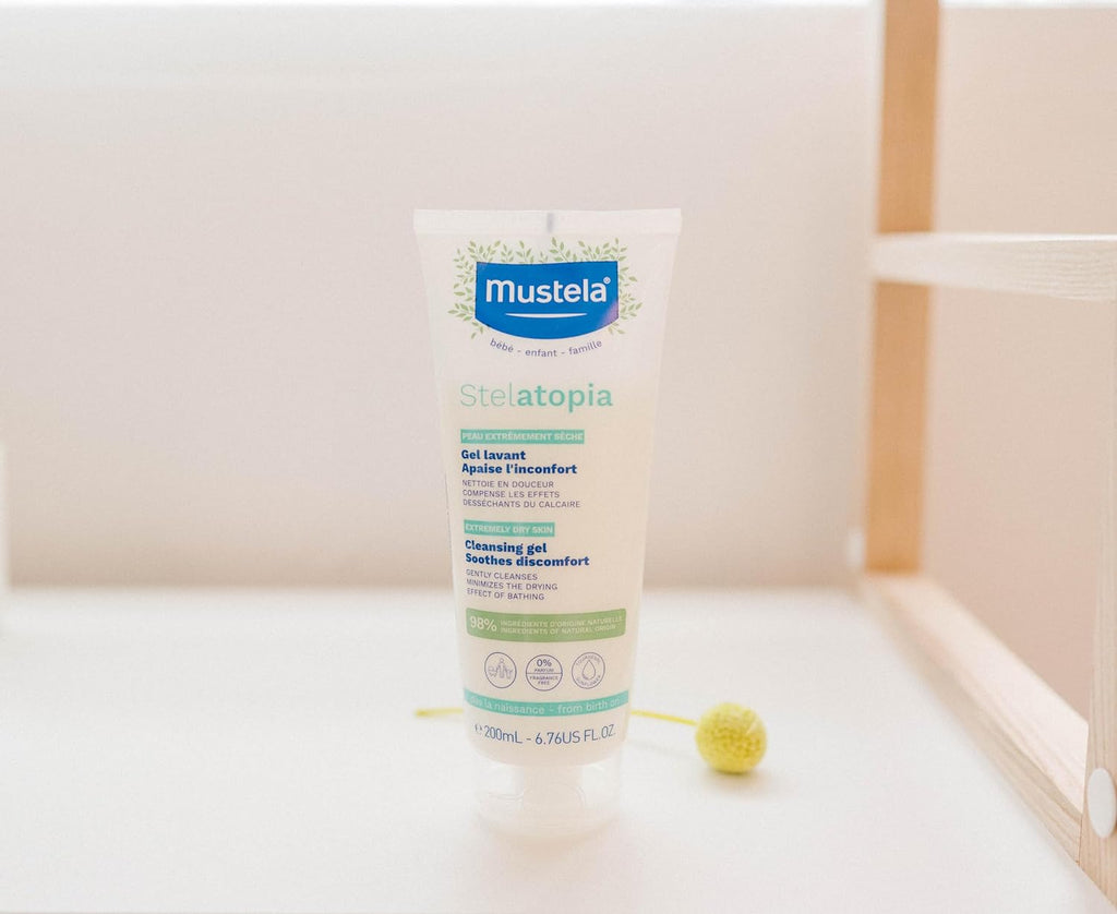 Full range of Mustela Stelatopia skincare collection featuring the Cleansing Gel with organic ingredients