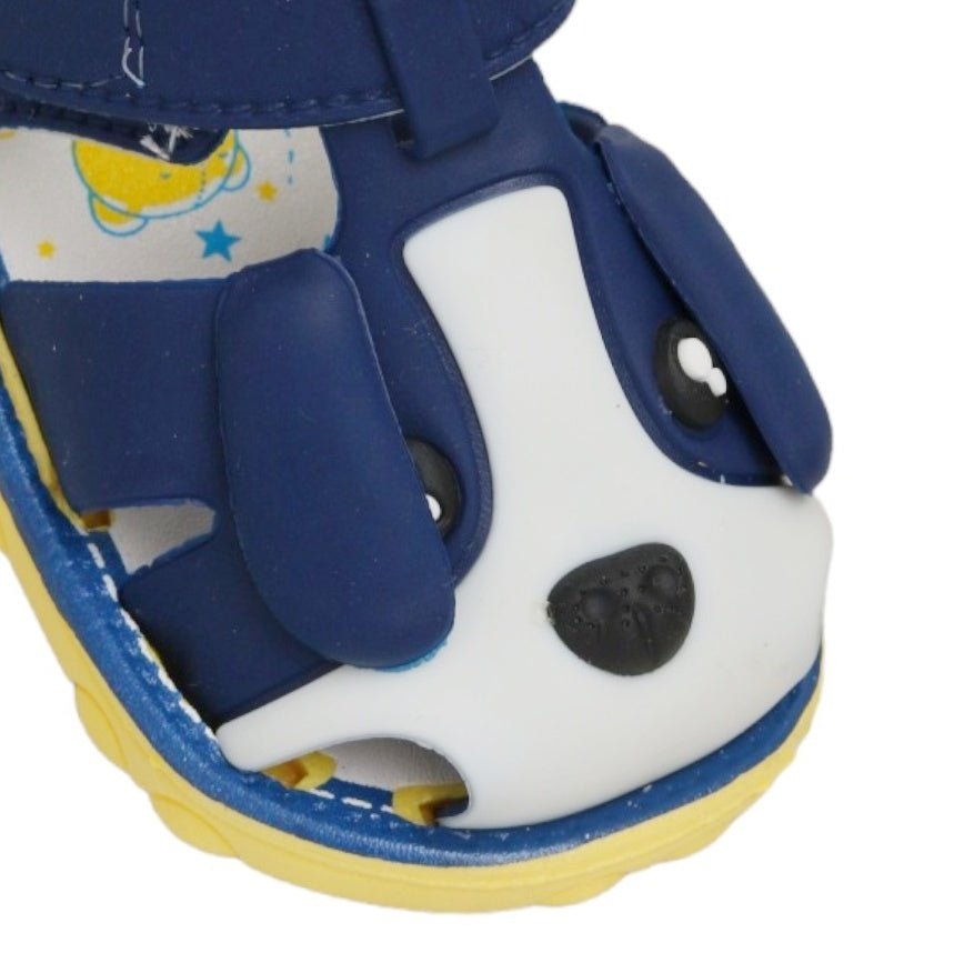 Close-up of the puppy face on blue applique children's sandal.